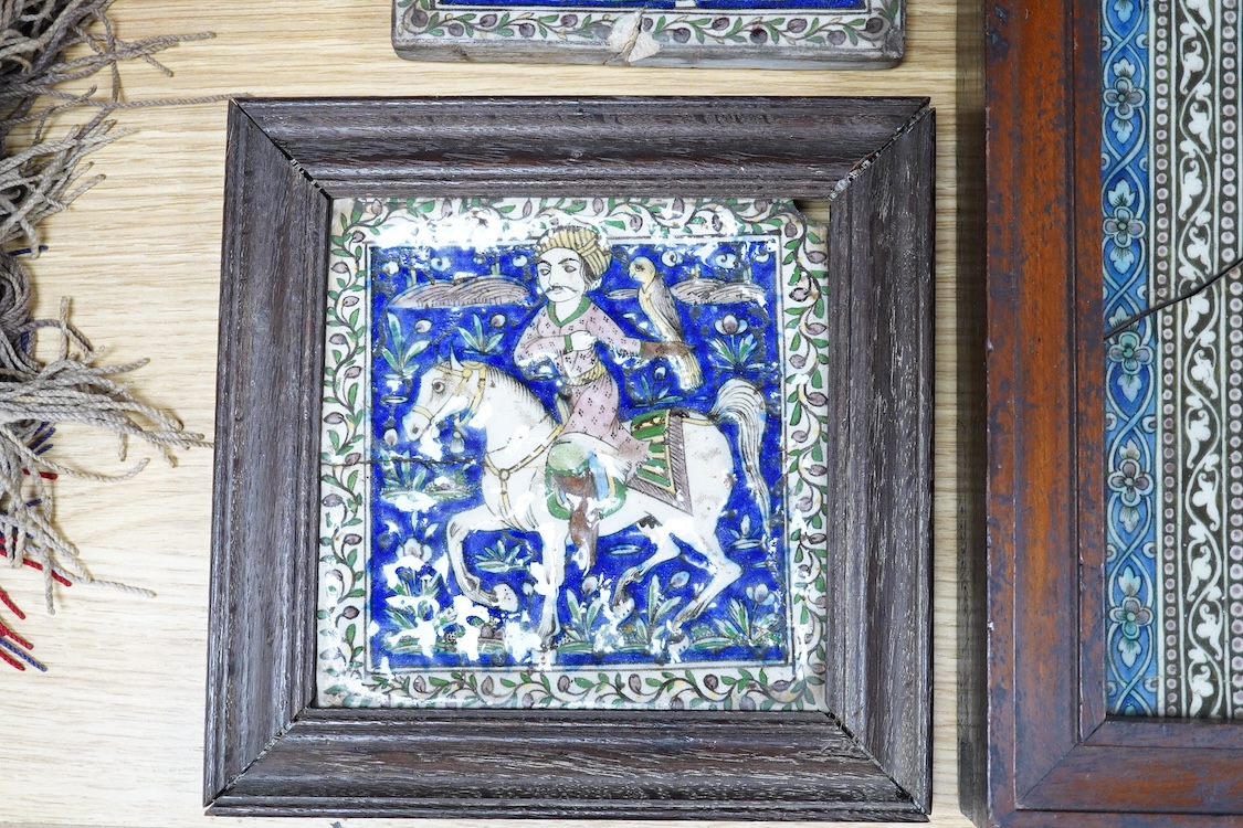 Four 18th/19th century Persian tiles, two depicting horses and riders and abstract flowers, three framed, largest 40 x 21cm